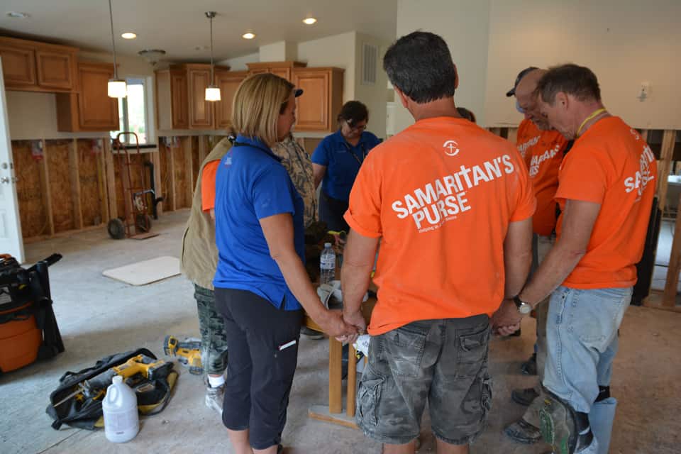 Billy Graham chaplains lead prayer with Samaritan's Purse volunteers at a flooded home in Grand Forks, British Columbia. (BGEA file photo)